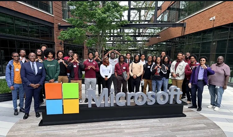 AARI students and staff gathered around the Microsoft sign during a site visit
